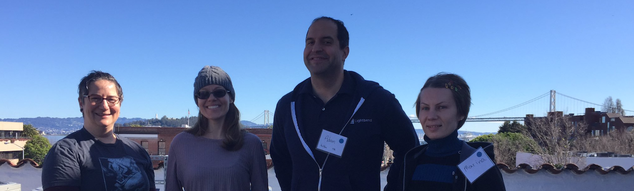 four smiling people with SF bay bridge in the background